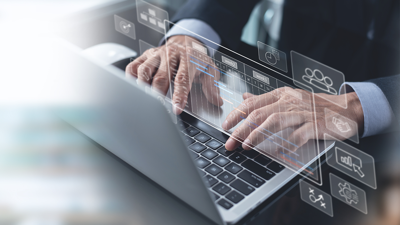 Business man's hands typing on laptop